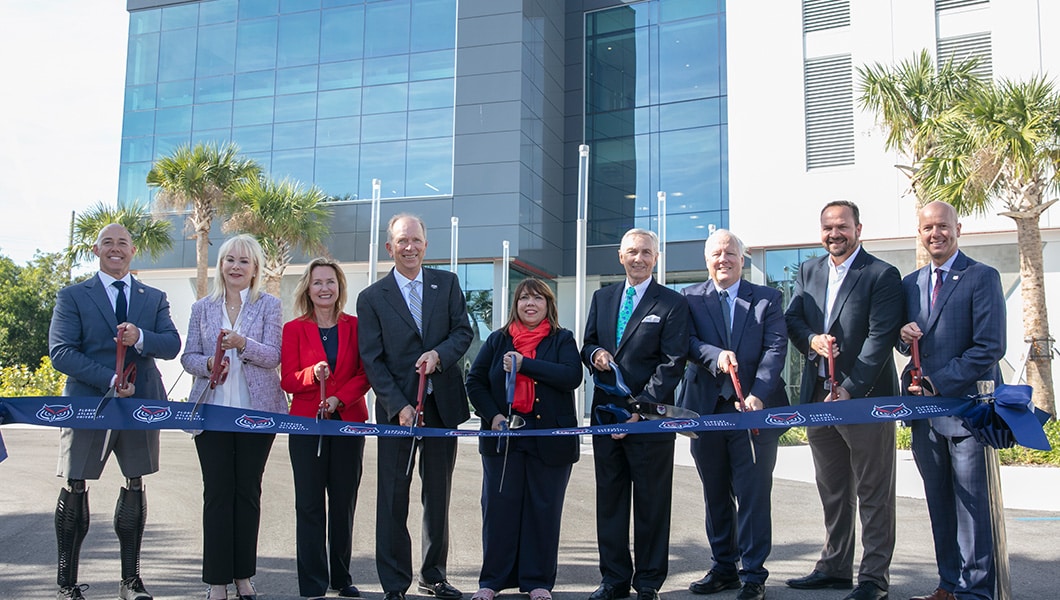 Group with large scissors cut ribbon