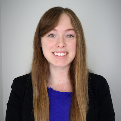 headshot of woman in blue shirt and black blazer
