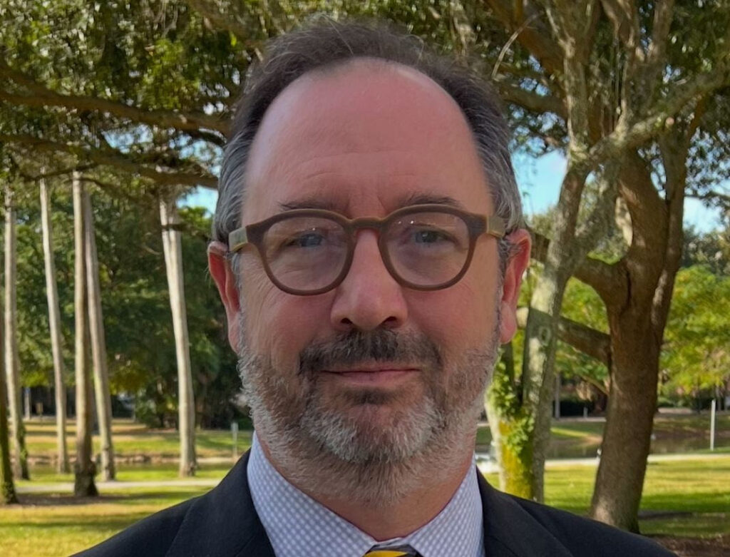 headshot of man in glasses with beard