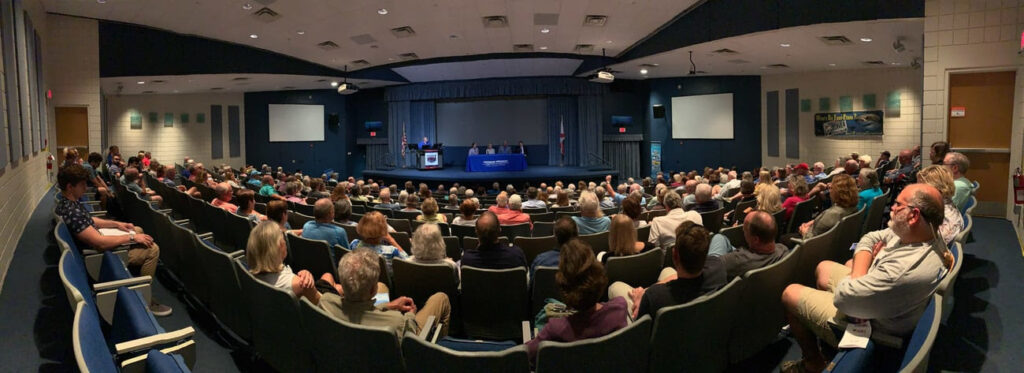 fish eye view of a lecture hall filled with adults and students